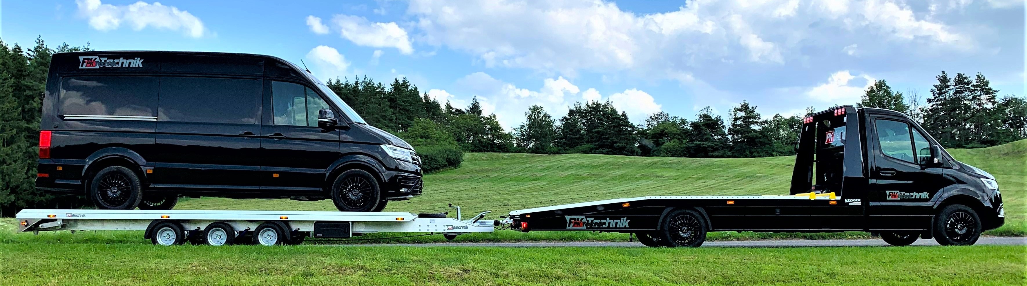 GROMEX three-axle aluminium car transporter carrying a commercial vehicle